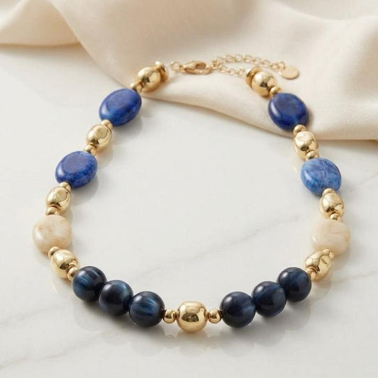 Collana Eclissi collezione artigianale in acciaio anallergico con pietre in resina e dettagli dorati per un look elegante e sofisticato