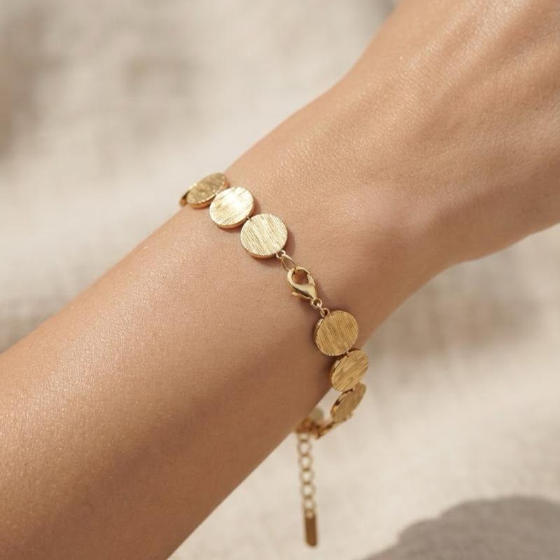 Bracciale Soleil in Acciaio Inossidabile con Disegno a Dischi Dorati e Argentati per un Look Elegante e Moderno